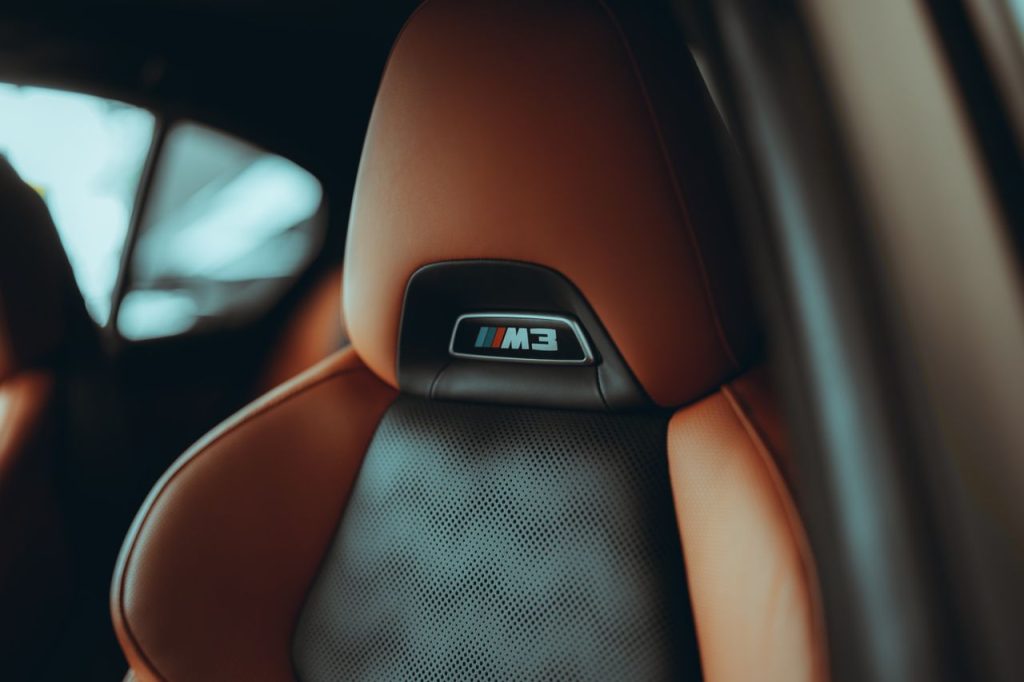 The Art of Drawing Readers In: Your attractive post title goes here Close-up of a luxury car seat with the M3 logo, showcasing premium leather and design.